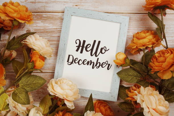 istock Hello December typography text with flower decoation on wooden background 1493696933