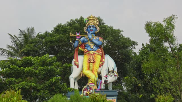 A wide view of the Lord Krishna statue on the temple, a supreme god in his own right