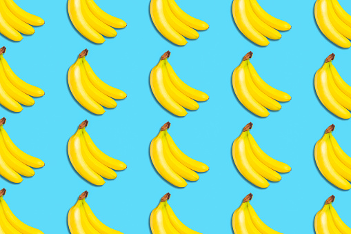 Lot ripe bananas. Bananas on blue background. Fruit background. Vegetables, fruits Food