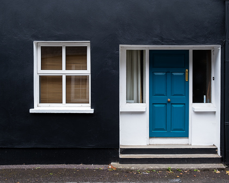 Traditional colourful house facade with closed window and door i. Kinsale Ireland