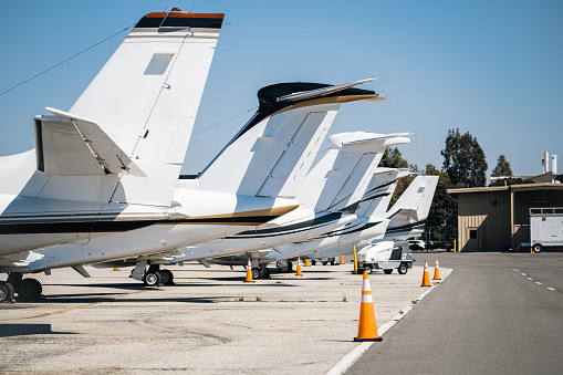 Several airplanes are parked at the airfield, awaiting their next flights or undergoing maintenance.