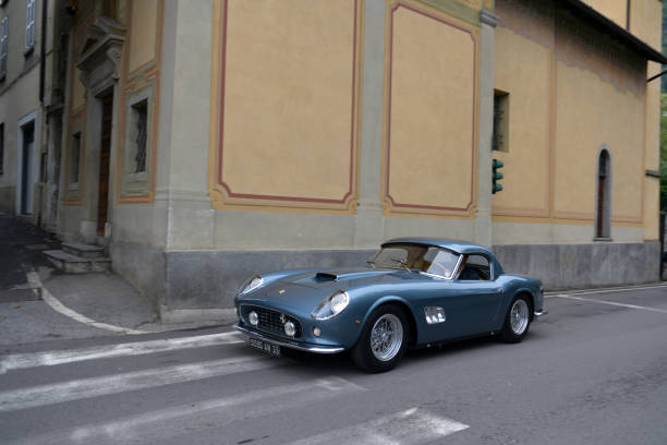 The Concorso Cernobbio, Como - May 21, 2023: Concorso d'Eleganza Villa d'Este 2023
A Ferrari 250 GT Spyder California, Spyder, Pininfarina/Scaglietti, 1961 drives through the streets of Cernobbio.
In Europe, the Concorso d'Eleganza Villa d'Este has developed into a meeting point for lovers of high-quality classic automobiles.
Active automotive designers are also looking for inspiration for their work there.
In addition, the event is given a special touch by the Villa d'Este, a former cardinal's palace with park, located directly on the lake
a neat setting and a social touch.
On Sunday, vehicles for the general public will be shown on the grounds of the neighboring Villa Erba.
The vehicles drive early in the morning from Villa d'Este to Villa Erba through the small town of Cernobbio
at Como
on the public road, on Via Regina

In the background you can see the church Chiesa di Maria delle Grazie.



The event traditionally takes place on the third weekend in May each year.

A jury decides on the two prizes "Best of Show" and the audience awards the "Coppa d'Oro Villa d'Este" as a further prize.
Assuming perfect condition, the criteria are beauty, rarity and emotionality.
Vehicles that have already received awards in previous years cannot be awarded again.
Since 2002, contemporary prototypes or concept vehicles have also been awarded. concorso stock pictures, royalty-free photos & images
