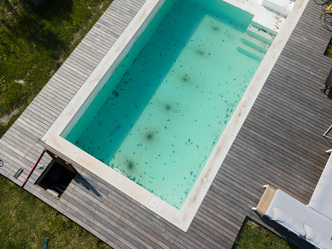 aerial drone photo of pool after winter, cleaning the plane, the pool, draining the dirty water, dirty pool before the spring