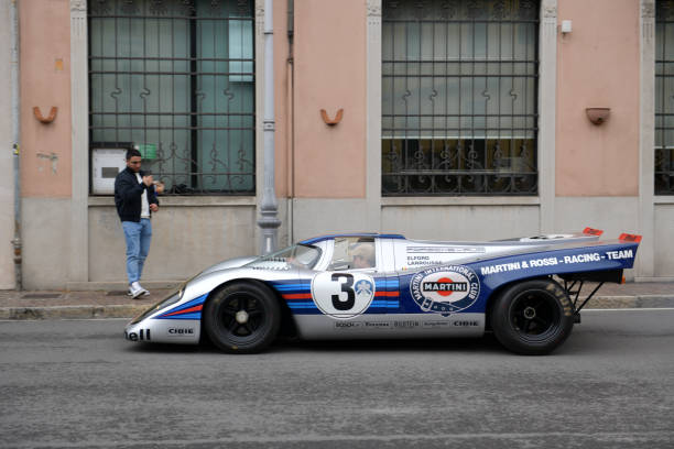 The Concorso Cernobbio, Como - May 21, 2023: Concorso d'Eleganza Villa d'Este 2023.
A 1971 Porsche
917K
Tech Specs
Engine Flat-twelve air-cooled engine, mounted midship, twin overhead camshafts, fuel-injected. 4907cc, 600hp.
Drives through on the public road on Via Regina Cernobbio.

In Europe, the Concorso d'Eleganza Villa d'Este has developed into a meeting point for lovers of high-quality classic automobiles.
Active automotive designers are also looking for inspiration for their work there.
In addition, the event is given a special touch by the Villa d'Este, a former cardinal's palace with park, located directly on the lake
a neat setting and a social touch.
On Sunday, vehicles for the general public will be shown on the grounds of the neighboring Villa Erba.
The vehicles drive early in the morning from Villa d'Este to Villa Erba through the small town of Cernobbio
at Como
on the public road, on Via Regina

In the background you can see the church Chiesa di Maria delle Grazie.



The event traditionally takes place on the third weekend in May each year.

A jury decides on the two prizes "Best of Show" and the audience awards the "Coppa d'Oro Villa d'Este" as a further prize.
Assuming perfect condition, the criteria are beauty, rarity and emotionality.
Vehicles that have already received awards in previous years cannot be awarded again.
Since 2002, contemporary prototypes or concept vehicles have also been awarded. concorso stock pictures, royalty-free photos & images