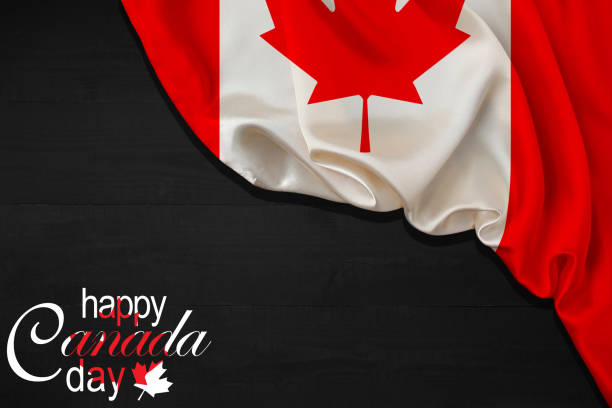 happy canada day calligraphy lettering with red maple leaf and a flag on black wood background. vector illustration. paper art style. 1st of july. - flag canada canadian flag maple leaf imagens e fotografias de stock
