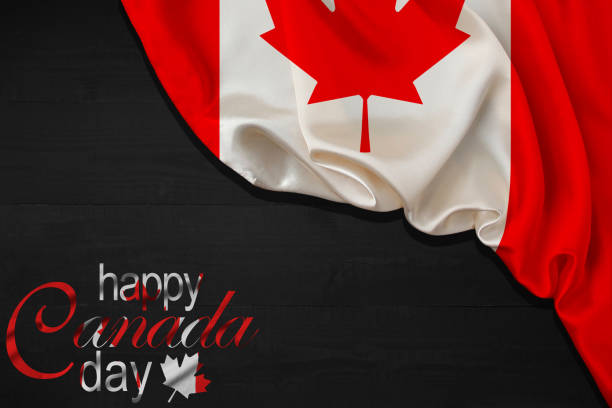 istock Happy Canada Day calligraphy lettering with red maple leaf and a Flag on black wood background. Vector illustration. Paper art style. 1st of July. 1493702281