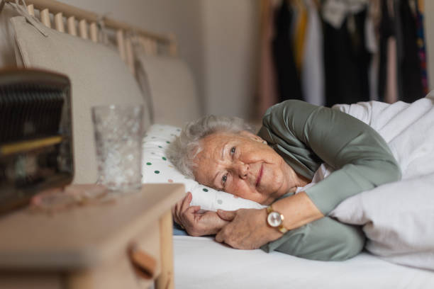 istock Senior woman sleeping in her bed alone. 1493707631