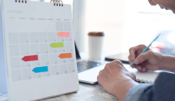 istock Planner or organizer plan daily schedule on 2022 calendar event planner. Asian business man planning work schedule. Calendar reminder event concept 1493713171