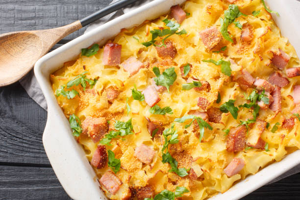 istock Creamy baked pasta with bacon and cheese closeup on the baking dish. Horizontal top view 1493718429