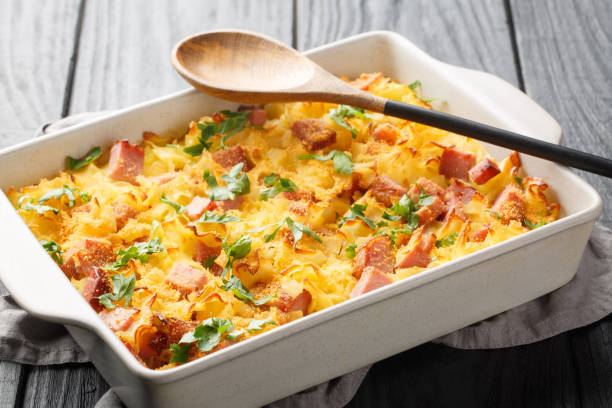 Creamy baked pasta with bacon and cheese closeup on the baking dish. Horizontal