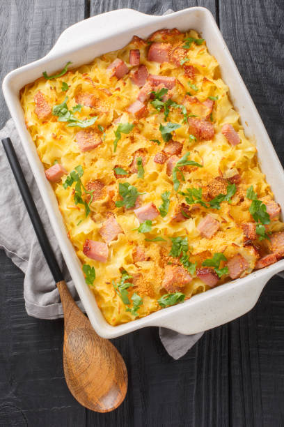 istock Traditional baked Austrian Schinkenfleckerl with Fleckerl pasta, ham, sour cream, eggs and breadcrumbs closeup on the baking dish. Vertical top view 1493718444