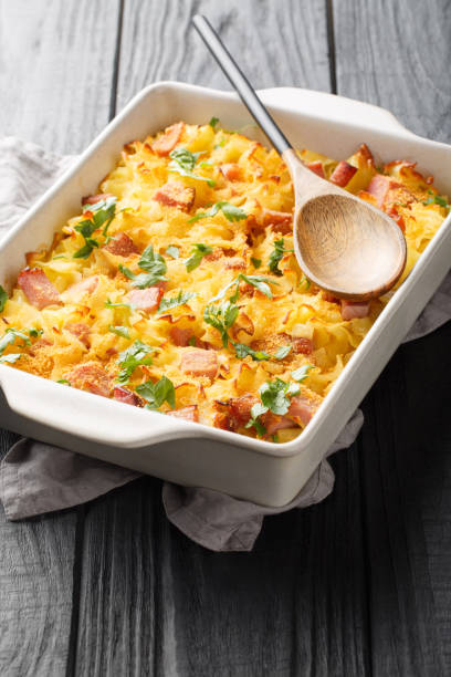 istock Traditional baked Austrian Schinkenfleckerl with Fleckerl pasta, ham, sour cream, eggs and breadcrumbs closeup on the baking dish. Vertical 1493718452