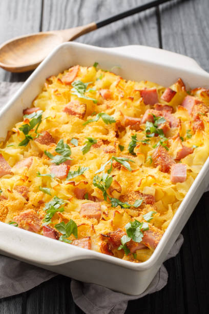 istock Uberbackene Schinkenfleckerl Gratinated Ham Pasta closeup on the baking dish. Vertical 1493719033