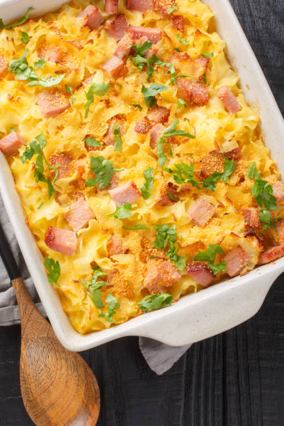istock Uberbackene Schinkenfleckerl Gratinated Ham Pasta closeup on the baking dish. Vertical top view 1493719047