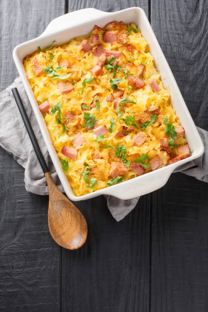 istock Austrian pasta Fleckerl baked with ham, sour cream egg sauce and breadcrumbs close-up in a baking dish. Vertical top view 1493719073