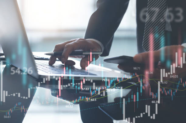 istock Businessman using laptop computer trading stock market with forex graph, economic growth chart, financial report 1493720485