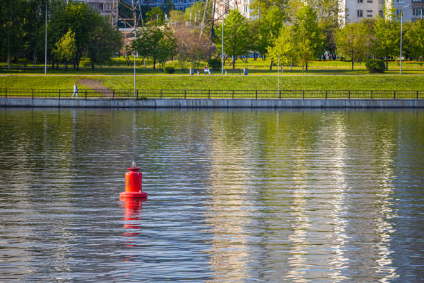 red lighthouse buoy on the river without a ship. red buoy