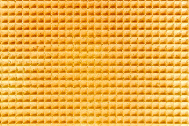 istock Waffle relief texture background. Sweet tasty dessert. Empty golden waffle texture, background for your design with copy space. Close-up pattern of a traditional Dutch waffle as a background. 1493723525