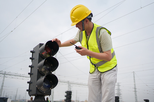 Engineer checking railway signal lights