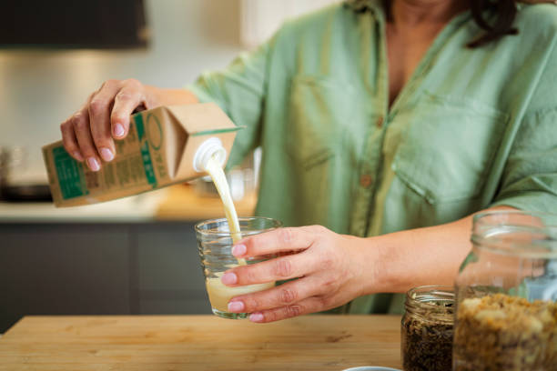 istock Woman pouring soy milk into a glass 1493725475