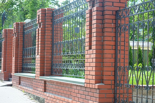 Modern stone fence with aluminum or metal Horizontal sections