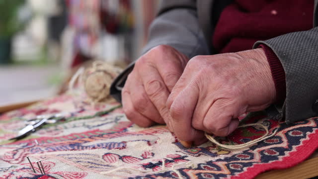 Old hand sewing carpet in istanbul