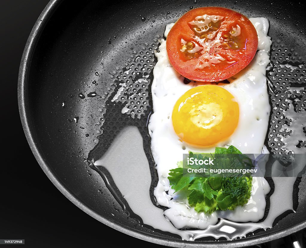 Fried egg with in shape of Traffic Light Original breakfast theme. Fried egg with tomato and greens in shape of Traffic Light in a frying pan Food Stock Photo