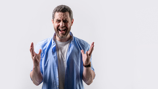 frustrated man express frustration in studio, copy space. photo of frustrated man shouting. frustration of frustrated man wearing shirt. frustrated man with frustration isolated on grey background.