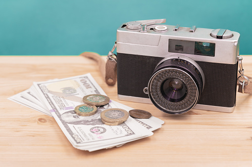 vintage camera with fake money for sell photograph or stock image photographer business career concept