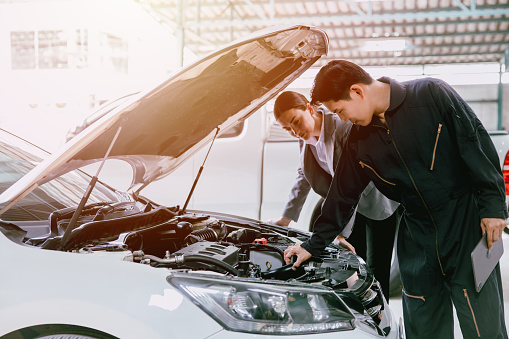 mechanic engineer working checking engine in garage auto shop car insurance claim cost estimate team