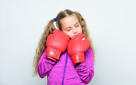 Girl cute child with red gloves posing on white background. Upbringing for leader. Strong child boxing. Sport and health concept. Boxing sport for female. Skill of successful leader. Sport upbringing.