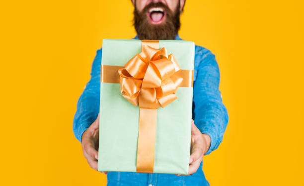 istock brutal bearded male man hold present or gift, party 1493733581