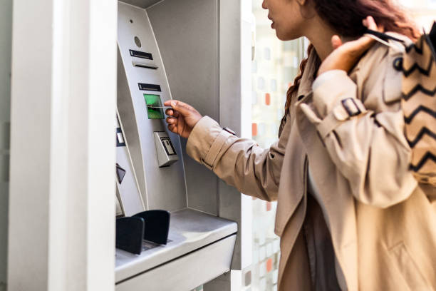 istock Young girl withdrawing money at ATM 1493734247