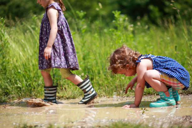 istock Two little girls in mud puddles 1493734307