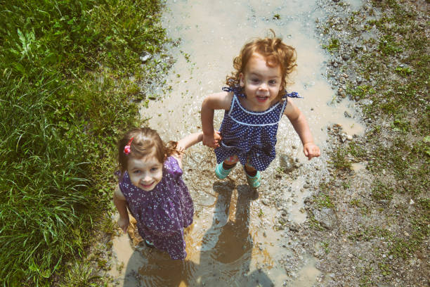istock Child enjoying a big puddle of mudd 1493734426