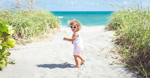 Cute little girl headed to the ocean in southeast Florida