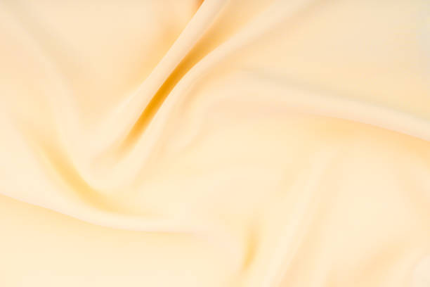 istock The Beautiful light yellow color silk texture as background. 1493736066