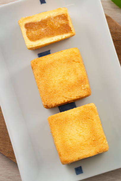 istock Delicious pineapple cake pastry in a plate on wooden table background with tea. 1493737723