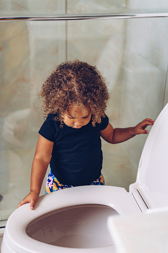 Little girl learning to use the toilet