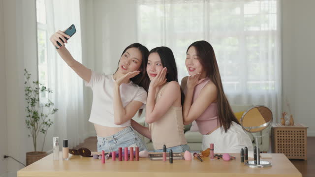 Young Asian Models Taking a Selfie after Makeup Application at Home