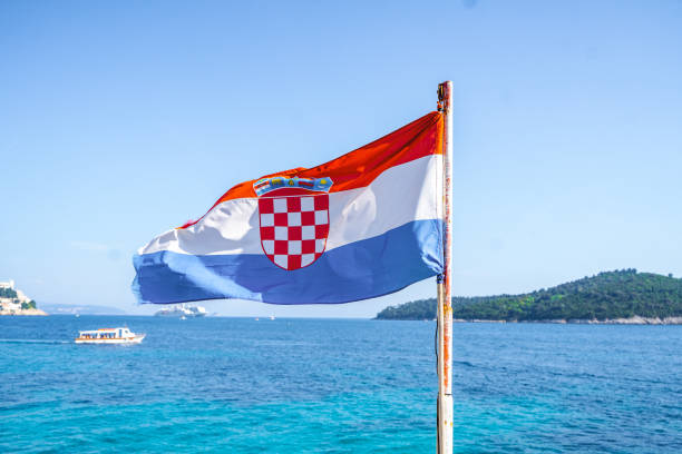Croatian flag on a windy day by the sea