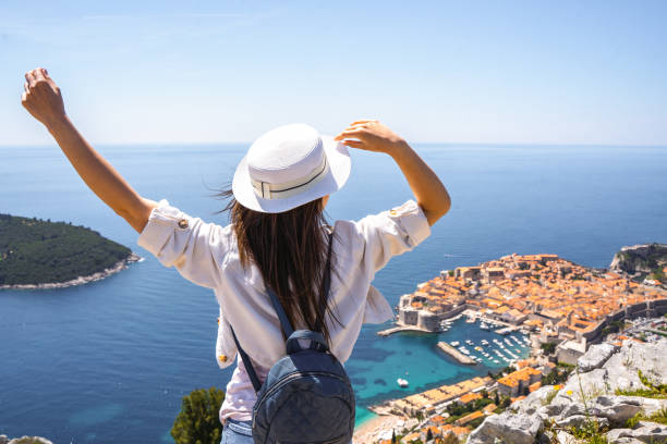 istock A woman standing at the costal viewpoint 1493741146