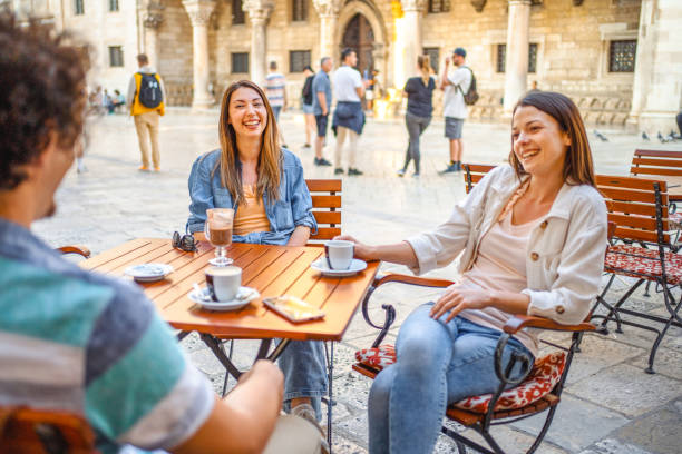 istock Three friends sitting in a coffee shop in town talking and drinking coffee 1493743405