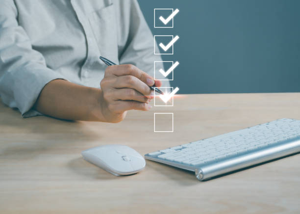 istock Businesspeople using laptop doing online checklist survey, filling out digital form checklist, take an assessment, business performance checklist, questionnaire, evaluation, online survey, online exam 1493744756