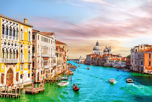 Gondolas and boats in the Grand Canal of Venice near Santa Maria della Salute, Italy.