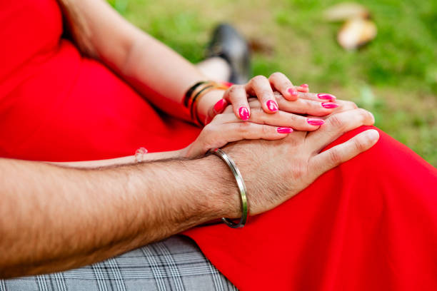 Hands of couple together, to be married, cute and loving relationship. stock photo