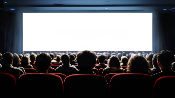 istock People in the cinema hall with empty white screen. 1493750135