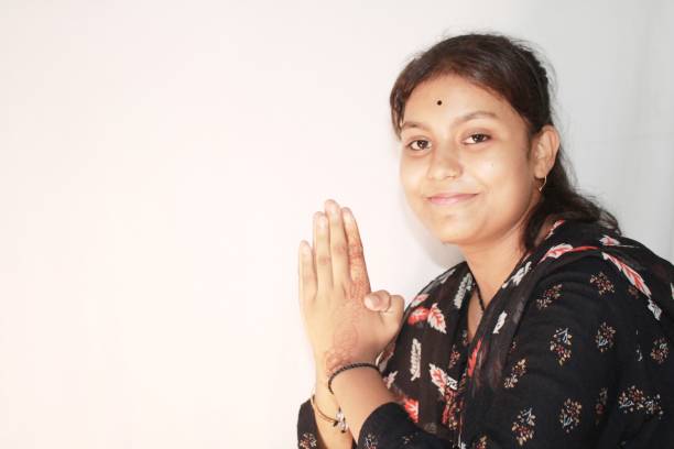 istock Indian Teenage girl greets with folded hands. 1493753402