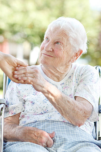 istock Senior Woman Holding Hands with Caretaker 149375461