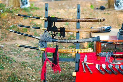 Selection and variety  of ancient styled southeast asian blades and swords. Equipment of stuntmen performing historical thai show at history event in Phitsanulok organized by government as public event